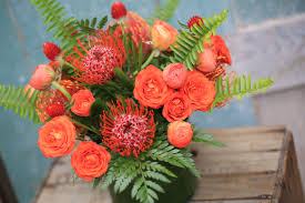 Florist and locally crafted gifts in rva. Orange And Green Pincushion Protea Gomphrena Spray Roses Ranunculus And Fern In A Leaf Wrapped Vase Brenna Co Spray Roses Strawberry Fields Wedding Flowers