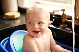 happy baby boy looking away while