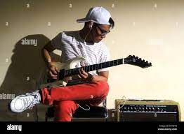 Photo of a teen playing an electric guitar Stock Photo - Alamy