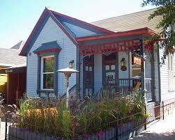 A Small Light Blue Wooden House With Dark Blue And In Some Cases Red Trim There Is A Small Plot With G Light Blue Houses Victorian House Colors Facade House