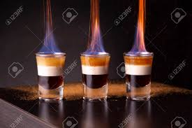 When prepared properly, the ingredients separate into three distinctly visible layers (due to their relative densities). Three Shots Of Flaming B 52 Cocktail Placed On A Bar Counter Stock Photo Picture And Royalty Free Image Image 142566436
