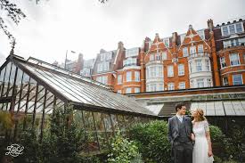 Bride And Groom Portrait Next To Glasshouse Greenhouse Chelsea Physic Garden Londo Yorkshire Wedding Photographer London Wedding Venues Garden Wedding Venue