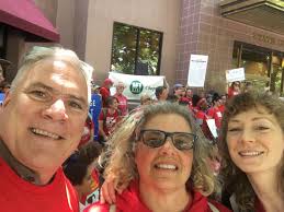 UC-AFT members John Rundin (UCD) and Ramona Collins (UCB) and field rep  Emily Rose (UCB) at Red for Ed Event at the Capitol in support of public  education! (In front of the