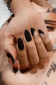 Matte Black Almond Shaped Nails Fancy Matte Black Nails Stiletto Shaped Design With Gold Glitter In 2020 Black Nail Designs Gold Glitter Nails Matte Nails Design