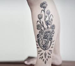 Grey flowers and human heart tattoo on upper back. Heart And Flower Tattoo The Flowers Ideas
