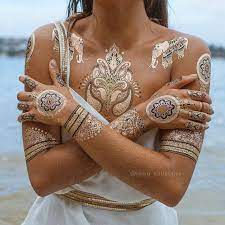 It takes a bit of time to apply a temporary tattoo perfectly, but with a little patience, you can rock either a transfer or stenciled glitter tattoo with pride. Metallic Temporary Tattoos Etsy Metallic Tattoo Temporary Gold Tattoo Henna Tattoo Designs