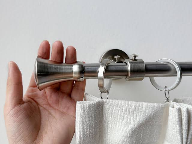Detail of premium gold-finished curtain rod and tieback hardware