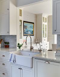 The change in cabinetry hardware finishes works here because these too sets of cabinets are made distinct by there paint colors and locations. Gray Farmhouse Kitchens Design Ideas