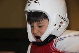 Shawn Juntunen, a 7-year-old green-belt taekwondo student,