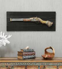 A room without lighting looks dull, so you can take a look at a wide variety of home decor products on pepperfry like wall shelves, clocks, lamps, mirrors, wall art, spiritual decor, etc. Buy Wrought Iron Rifle Gun In Golden Wall Art By Malik Design Online Abstract Metal Art Metal Wall Art Home Decor Pepperfry Product