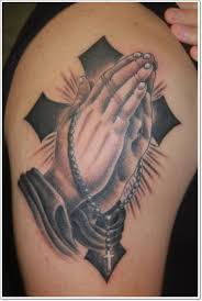 A praying hands tattoo on the back with a cross and rosary for women. Big Black Ink Cross With Praying Hands Tattoo On Upper Arm Tattooimages Biz