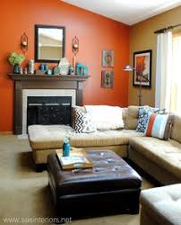 Simple scandinavian living room with mustard yellow sofa, orangey hardwood walls, a floor lamp, and a stylish round scandinavian center table. 20 Burnt Orange Living Room Ideas Living Room Orange Burnt Orange Living Room Living Room Decor