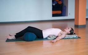 A yoga bolster can support you and help you relax for your personal yoga therapy. Heart Opening Restorative Yoga Poses Valerie Costello Motherhood Photography Wellness