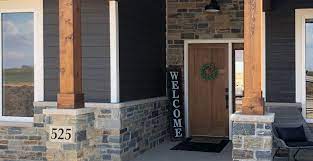 The stone veneer on the face of the fireplace is locally sourced fieldstone. Front Yard Landscaping Porch Siding Ideas Stone Veneer Outdoor Patio Buechel Stone