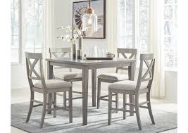It has a small dining table for four that sits on hardwood flooring. Parellen Gray Counter Dining Table W 4 Bar Stool Furniture Exchange