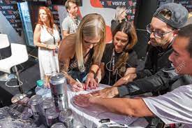 BERLIN, GERMANY - OCTOBER , 2019: Woman Actress Works At Visit-X Online  Porno Video Live Sex Cams Booth During 23th Venus Erotic And Lifestyle  Trade Fair In Messe Exhibition Hall. Фотография, картинки,