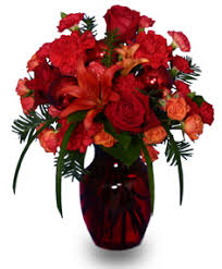 We always go the extra mile to make your floral gift perfect. Ruby Red Regalia Vase Arrangement Festive Flowers Flower Shop Network Christmas Floral Designs