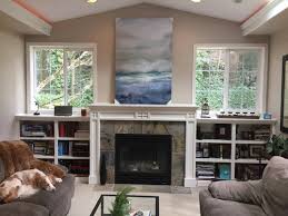 The framed picture above the fireplace is a motorized vutec art screen. Is This Abstract Art Piece Too Large For Above Fireplace