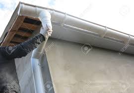 Now that we are well aware of the various gutter downspout sizes and styles, let us dig deeper into the materials used for effective downspouts and how much they shall cost. Contractor Installing Roof Gutter Downspout Pipe Stock Photo Picture And Royalty Free Image Image 100587336
