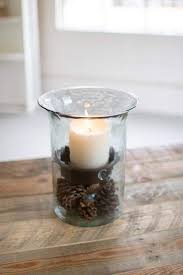The whole arrangement sits on an iron base with fancy scrolled legs. Glass Hurricane Candle Holders
