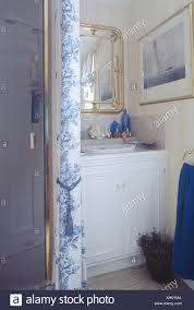 blue and white floral curtain beside