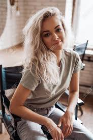 Thinking of changing your hair colour and going blonde? Cool And Smiling Young Female Model With Blond Curly Hair And White Boots Posing On A Make Up Chair In A Bright Room In Front Of Mirrors Looking Cute And Interested Stock