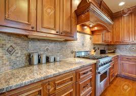curved kitchen hood over a subway tiled