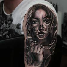 We provide quality tattoo and piercing services. Mexican American Style Tattoo On The Left Upper Arm And
