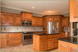 Uba tuba with oak and variegated tannish tiles with white and some slight streaks of black. Backsplash With Uba Tuba Granite Countertop Google Search Maple Kitchen Cabinets Hickory Kitchen Wood Kitchen