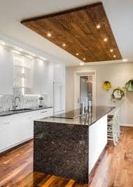 With all modern kitchen fixtures you can simply use this kitchen ceiling ideas as your reference. Contemporary White Kitchen With Wood Panel Ceiling Accent Kitchen Ceiling Design House Ceiling Design Kitchen Lighting Design