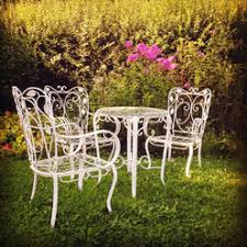 This stops the wood from cracking and splitting. White Iron Garden Furniture Three Chairs One Table Germany Stockphoto