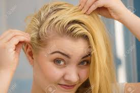 If you have oily hair, you probably find that you want to shampoo your hair almost every day. Blonde Woman Having Problems With Greasy Oily Hair Looking At Stock Photo Picture And Royalty Free Image Image 121070034