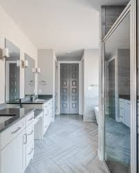 It works perfectly with the simple white sanitaryware and black details in the grey bathroom. Gray Modern Master Bathroom With Herringbone Tile Floor Modern Master Bathroom Herringbone Tile Floors Master Bathroom