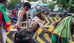 Hindu devotees dance with heavy and prickly kavadis decorated with flowers and peacock. Thaipusam Festival Kuala Lumpur On Foot