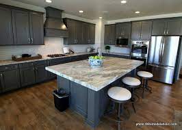 Modern gray kitchen features dark gray flat front cabinets paired with white quartz countertops and a glossy blue care tile. Remodelaholic 40 Beautiful Kitchens With Gray Kitchen Cabinets