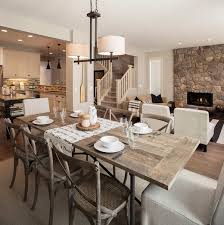 A rustic dining table and chairs set in a dining room situated near the glass windows overlooking the relaxing farmland. Farm Table Design Ideas Beautiful Solid Wood Dining Tables
