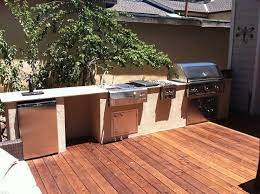 An outdoor kitchen can extend your deck and create a cozy place for meetings in all seasons. Wood Deck And Outdoor Kitchen At Rianda Klassisch Patio Sonstige Von Brazil Construction