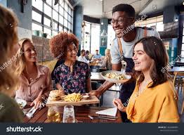 Waiter Serving Group Of Female Friends Meeting For Drinks And Food In Restaurant Ad Sponsored Group Female Waite Fast Healthy Meals Fast Food Menu Waiter