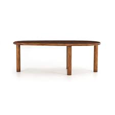 A simple round of glass on a pedestal support, with matching wicker chairs around it. Kidney Shaped Hobbs Dining Table Pine Finish Mobilia
