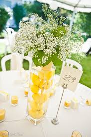 Yellow Is So Summery And Pretty Lemons Submerged In Water In Tall Vases As Wedding Water Wedding Centerpieces Lemon Themed Bridal Shower Lemon Centerpieces