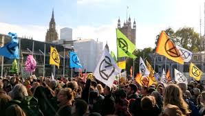 Police responding to protesters who have blocked roads around westminster campaigners held placards with messages including code red, where's the action while four people were dressed as the ocean in a warning over rising sea levels. Extinction Rebellion Direct Action To Save The Planet From Climate Change Desmog