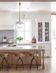 White shaker cabinetry is the ideal choice for farmhouse kitchens because of its effortless design and bright color. Get The Look Natural Wood Kitchen Lark Linen Interior Design Kitchen Kitchen Design Home Kitchens