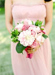 Gorgeous bride posing with bridesmaids in pink dresses, holding stylish bouquets in warm evening light in summer park. Pretty Pink Napa Affair Wedding Green Wedding Bouquet Blush Pink Bridesmaid Dresses