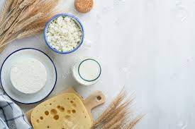 Shavuot Jewish Holiday Celebration. Kosher Fresh Dairy Products Milk And  Cheese, Ripe Wheat, Cream On White Wooden Background. Dairy Products Over  White Wooden Background. Shavuot Concept. Top View. Фотография, картинки,  изображения и