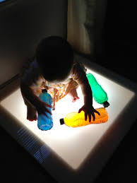 Light Table Play With Babies Water Bottles Filled With Half Colored Water And Half Vegetable Oil Via Reggio Children Light Box Activities Infant Activities