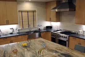A brown glazed ceramic chicken injects the farmhouse nuance into the area. White Marble Lynia Interlocking Backsplash Tile