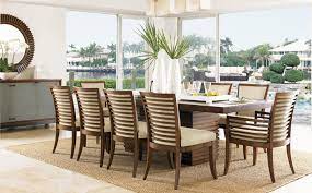 The chair features a tight linen weave constructed in an ivory and gold coloration. Indoor Collections Tommy Bahama Furniture