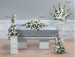 This large arrangement consists of white and pink roses, small and large daisies, fern leaves, and a few white chrysanthemums. White Funeral Flower Package H1949 Funeral Flowers Delivery In Toronto The Gta