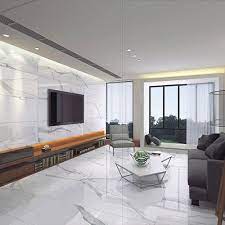 White marble a large slab of marble on the floor is the perfect way of having a trendy yet contemporary white element in the living room space. White Calacatta Marble Effect Polished Thin Porcelain Wall Floor Tiles Living Room Tiles Marble Floor Living Room White Marble Floor