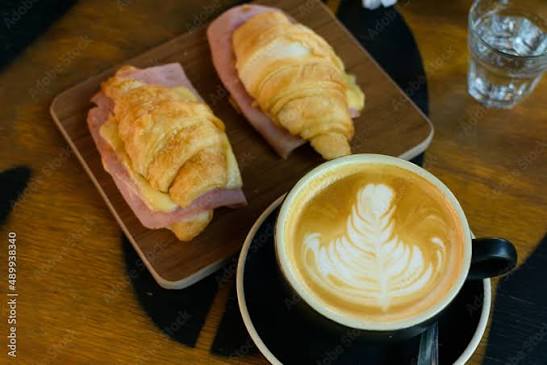 Café con leche y medialunas con jamón y queso Stock Photo | Adobe Stock